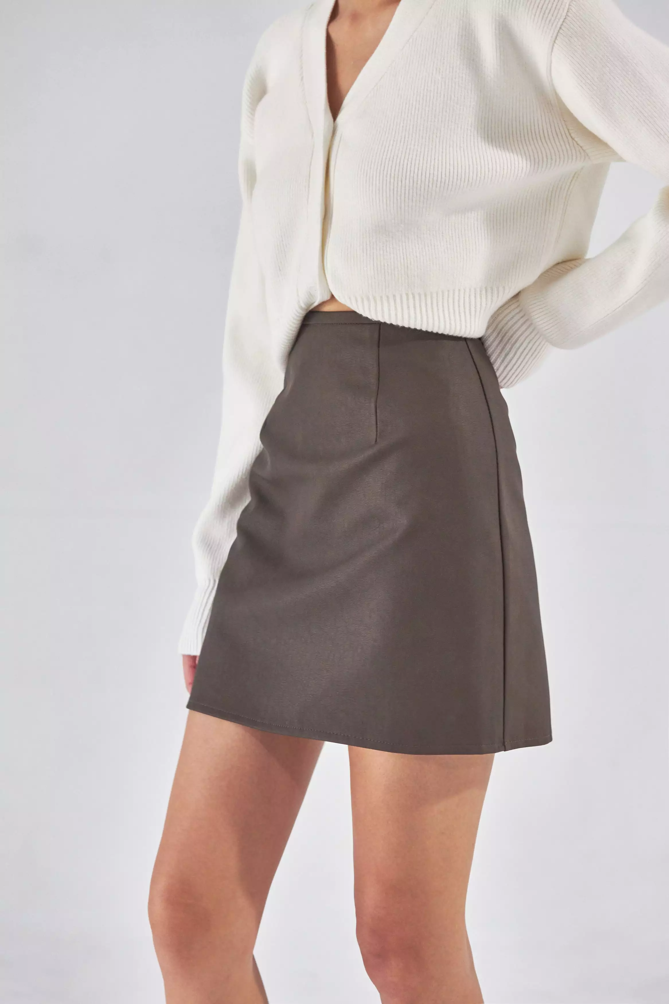 Brown faux leather skirt with confident style.