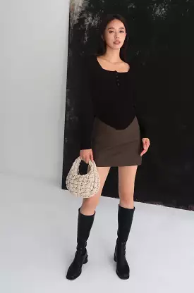 Brown faux leather skirt with confident style.